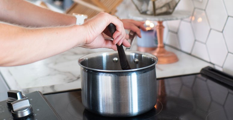 Woman stirring food with non-stick utensil