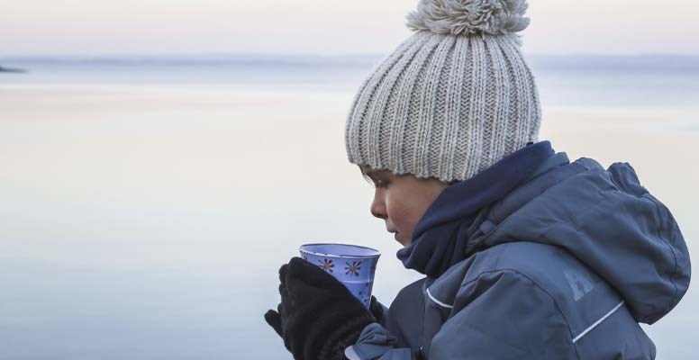 Boy drinking water in cold weather