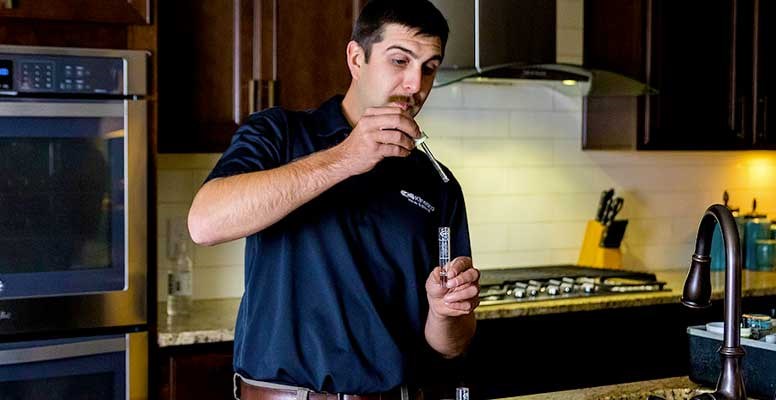 Water Specialist Performing In-Home Water Test