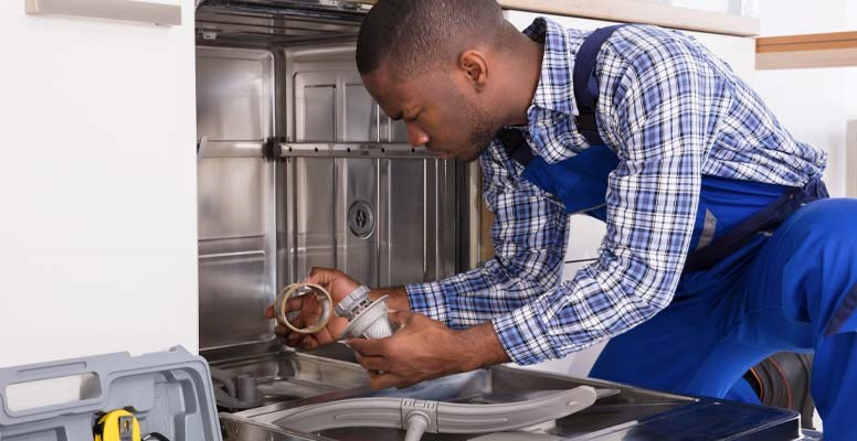 Man repairing dishwasher parts