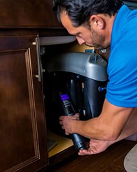 Kinetico service technician changing water filter
